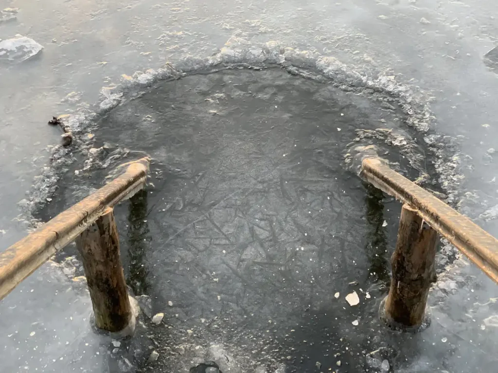 A hole cut through the ice of a lake.
